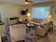 Another view of living room with wood-look floors and cozy furniture at 10173 Se 175Th Ln, Summerfield, FL 34491