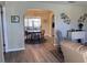 Open-concept living room and dining area with an archway to the kitchen, featuring neutral walls and hard flooring at 10173 Se 175Th Ln, Summerfield, FL 34491