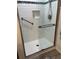 Newly remodeled walk-in shower with white subway tile, grab bars and frameless glass enclosure at 10173 Se 175Th Ln, Summerfield, FL 34491