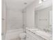 Clean bathroom with white vanity and marble tile at 105 Juniper Run, Ocala, FL 34480