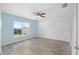 Bright bedroom with light blue walls and wood-look flooring at 105 Juniper Run, Ocala, FL 34480