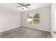 Bright bedroom with ceiling fan and wood-look flooring at 105 Juniper Run, Ocala, FL 34480