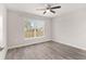 Bright bedroom with ceiling fan and wood-look flooring at 105 Juniper Run, Ocala, FL 34480