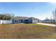 Single-story home with a white fence and a grassy yard at 105 Juniper Run, Ocala, FL 34480