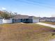 Single-story home with a blue exterior and two-car garage at 105 Juniper Run, Ocala, FL 34480