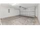 Spacious garage with concrete floor and overhead storage at 105 Juniper Run, Ocala, FL 34480