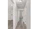 Light and airy hallway with wood-look flooring at 105 Juniper Run, Ocala, FL 34480