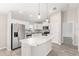 Modern kitchen with white cabinets, granite countertops, and stainless steel appliances at 105 Juniper Run, Ocala, FL 34480