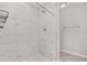 Updated shower with marble-look tile and modern fixtures at 105 Juniper Run, Ocala, FL 34480