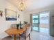 Bright dining area with wood table, access to patio, and modern chandelier at 11267 Sw 62Nd Avenue Rd, Ocala, FL 34476