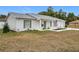 A charming light-grey single-story home with American flag and landscaping at 11267 Sw 62Nd Avenue Rd, Ocala, FL 34476