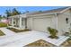 View of the garage and landscaped yard of a single story house at 11267 Sw 62Nd Avenue Rd, Ocala, FL 34476