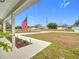 Inviting front porch with American Flag and mature plants at 11267 Sw 62Nd Avenue Rd, Ocala, FL 34476