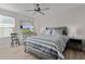 Bedroom with gray bed, dresser, and TV at 11414 Roma Rd, Oxford, FL 34484