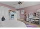 Pink bedroom with bed, dresser, and unicorn wall art at 11414 Roma Rd, Oxford, FL 34484