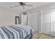 Bedroom with blue and white bedding and double door closet at 11414 Roma Rd, Oxford, FL 34484