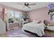 Pink bedroom with a bed, desk, and plenty of storage at 11414 Roma Rd, Oxford, FL 34484