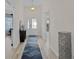 Bright entryway with light wood floors, a rug, and console table at 11414 Roma Rd, Oxford, FL 34484