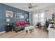 Living room with gray sofa, white coffee table, and workspace at 11414 Roma Rd, Oxford, FL 34484