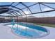 Stunning kidney-shaped pool with water feature and screened enclosure at 11414 Roma Rd, Oxford, FL 34484