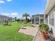 Landscaped backyard with patio and screened porch at 12413 Se 176Th Loop, Summerfield, FL 34491