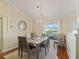 Elegant dining room with chandelier and arched window at 12413 Se 176Th Loop, Summerfield, FL 34491