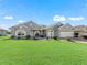 Gray two-story house with landscaped lawn and two-car garage at 12413 Se 176Th Loop, Summerfield, FL 34491