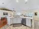 Eat-in kitchen with island, stainless steel appliances, and white cabinets at 12413 Se 176Th Loop, Summerfield, FL 34491