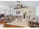 Living area with floral couches and a view into the dining area at 12413 Se 176Th Loop, Summerfield, FL 34491