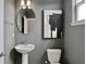 Stylish powder room with pedestal sink and toilet at 13233 Peaceful Melody Dr, Winter Garden, FL 34787