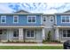 Two-story townhome with blue siding, stone accents, and landscaping at 13237 Peaceful Melody Dr, Winter Garden, FL 34787