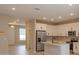 Modern kitchen with stainless steel appliances and entryway at 13237 Peaceful Melody Dr, Winter Garden, FL 34787