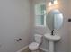 Stylish powder room featuring pedestal sink and round mirror at 13241 Peaceful Melody Dr, Winter Garden, FL 34787