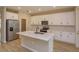 Modern kitchen with white cabinets, quartz countertops and island at 13241 Peaceful Melody Dr, Winter Garden, FL 34787