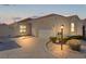 Evening view of a single-story villa with a garage and well-maintained landscaping at 1341 Lajolla Cir, The Villages, FL 32159