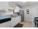 White cabinets, light blue countertops, and stainless steel appliances in the kitchen at 1341 Lajolla Cir, The Villages, FL 32159