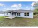 Expansive backyard showcasing the outdoor living space and manicured lawn at 15065 Se 93Rd Ave, Summerfield, FL 34491