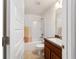 Bathroom featuring a shower-tub combination and a vanity with a faux marble countertop at 15065 Se 93Rd Ave, Summerfield, FL 34491