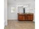 Bathroom featuring a double vanity, tile floor, and large mirror at 15065 Se 93Rd Ave, Summerfield, FL 34491