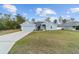 Charming one-story home with a well-manicured lawn, two car garage, and light blue painted siding at 15065 Se 93Rd Ave, Summerfield, FL 34491