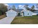 Charming one-story home with a well-manicured lawn, two car garage, and light blue painted siding at 15065 Se 93Rd Ave, Summerfield, FL 34491