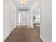 A welcoming foyer featuring ceramic tile, and a glass paneled front door at 15065 Se 93Rd Ave, Summerfield, FL 34491