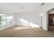 Bright and airy living room featuring neutral carpet and a large window at 15065 Se 93Rd Ave, Summerfield, FL 34491