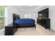 Main bedroom features a dark wood dresser, walk-in closet, and neutral carpet at 15065 Se 93Rd Ave, Summerfield, FL 34491