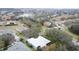 Wide aerial view showing the house, neighborhood, and surrounding landscape at 163 Crepe Myrtle Dr, Groveland, FL 34736