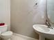 Small bathroom with toilet and pedestal sink at 163 Crepe Myrtle Dr, Groveland, FL 34736