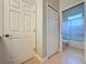 Bathroom with toilet, shower, and double door linen closet at 163 Crepe Myrtle Dr, Groveland, FL 34736