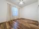 Bedroom with wood-look floors and sheer curtains at 163 Crepe Myrtle Dr, Groveland, FL 34736