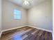 Simple bedroom with wood-look flooring and ceiling fan at 163 Crepe Myrtle Dr, Groveland, FL 34736