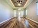 Bright bedroom featuring a sliding barn door and wood-look floors at 163 Crepe Myrtle Dr, Groveland, FL 34736